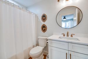 a bathroom with a toilet and a sink and a mirror at Newly Built Home with Mtn Views in Black Mountain! in Black Mountain +25 photos