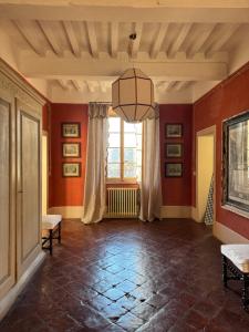 a living room with red walls and a large window at La Colombarola in Pieve Otto Ville