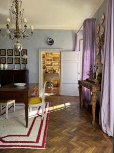 a living room with a table and a chandelier at La Colombarola in Pieve Otto Ville +19 photos