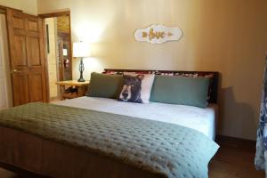 a bedroom with a bed with a dog on the pillow at Love Shack in Sevierville