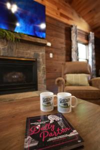 a table with two coffee cups and a book on it at Love Shack in Sevierville