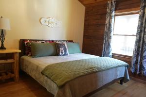 a bedroom with a bed and a window at Love Shack in Sevierville