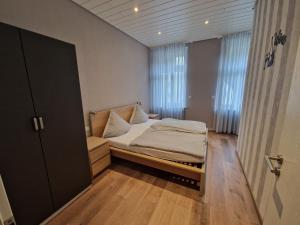 a small bedroom with a bed and a window at Weingut Haxel in Cochem
