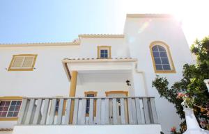a white house with a wooden porch at Villa Da Duarte - walkable to beach shops bars in Albufeira