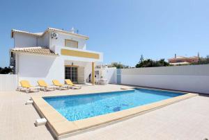 a villa with a swimming pool in front of a house at Villa Da Duarte - walkable to beach shops bars in Albufeira