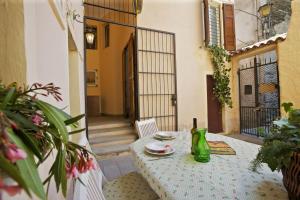 a table with plates and a bottle of wine on a patio at Casa Maria Vittoria in Cannero Riviera