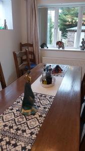 a wooden table with a figurine on top of it at Meadow View in Chalford +5 photos