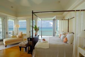 a bedroom with a bed with a view of the ocean at Blessed to Dream Villas in Long Bay Village +27 photos