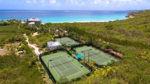 an aerial view of two tennis courts near the ocean at Blessed to Dream Villas in Long Bay Village