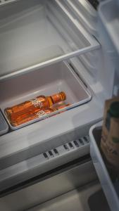 an open refrigerator with a bottle of sauce in it at WowNavigli Apartment-Sofa Bed Metro M4 Tram 2 in Milan