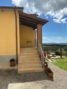 a set of stairs leading up to a house at COZY ALBA apartment in Sasso dʼOmbrone