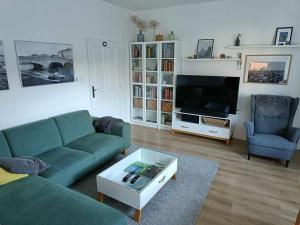 a living room with a couch and a tv at Apartmán v záhrade in Trnávka