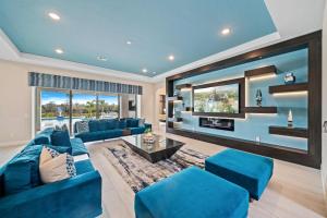 a living room with blue couches and a tv at Bear's Den At Reunion Resort-TB024 in Kissimmee