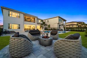 a home with a patio with couches and a fire pit at Bear's Den At Reunion Resort-TB024 in Kissimmee