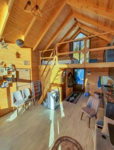 a living room with a staircase in a cabin at AKUTSA cottages in Keda