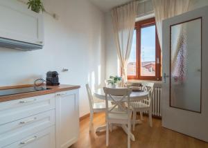 a kitchen and dining room with a table and chairs at La terrazza sul Ricetto - Guest House in Candelo