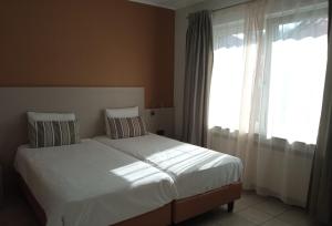Postel nebo postele na pokoji v ubytování Appart-Hotel Gwendy
