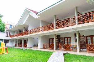 a building with a lawn in front of it at Laguna Azul Hotel & Suites in Sauce
