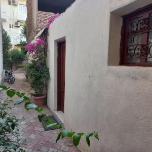 a white building with a door and a window at Remal City in Luxor