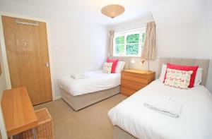 a bedroom with two beds and a window at Green Cottage in Porthmadog