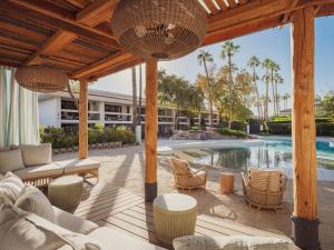 an outdoor patio with furniture and a swimming pool at The Scott Resort & Spa in Scottsdale
