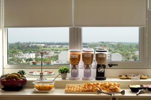 a counter with three glasses of food and a window at Amerian Rafaela Hotel in Rafaela