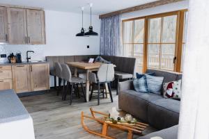 a living room with a couch and a table at Samnaun, ChaletdMot in Samnaun