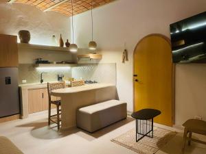 a kitchen with a table and a yellow door at Casa Ceiba San Pancho in San Francisco