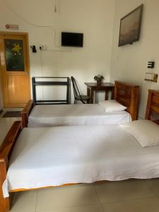 Rúm í herbergi á Hotel Change,Badulla