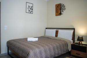 a bedroom with a large bed with two pillows at Nastas-Home in Igoumenitsa