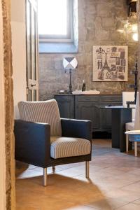 a living room with a chair and a table at Corte Delle Nobili in Viterbo