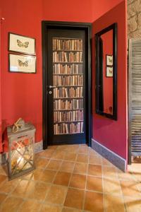 a room with red walls and a door with books at Corte Delle Nobili in Viterbo