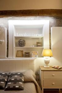 a bedroom with a window above a bed and a desk at Corte Delle Nobili in Viterbo