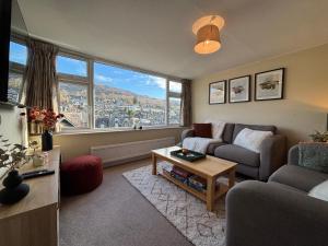 a living room with a couch and a table at Rothay Cottage in Ambleside