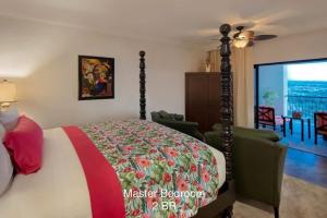 a bedroom with a bed and a living room at 4BD Oceanfront Unit Vista Encantada - Cabo in Cabo San Lucas