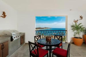 a table and chairs in a kitchen with a view of the ocean at 4BD Oceanfront Unit Vista Encantada - Cabo in Cabo San Lucas
