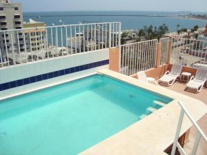 a swimming pool on the balcony of a building at Hotel Posada del Carmen in Veracruz