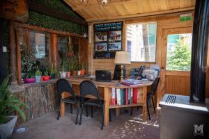 an office with a desk with chairs and a computer at Hebes House Hostal in Caviahue