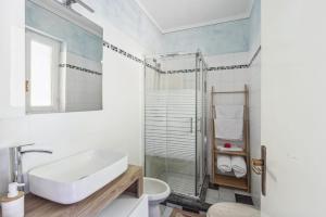 a white bathroom with a sink and a shower at La Veduta in Cannobio +19 photos