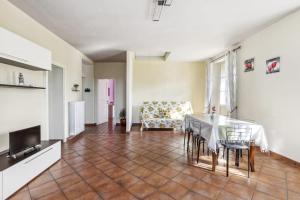 a living room with a table and a chair at La Veduta in Cannobio