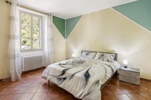 a bedroom with a bed and a window at La Veduta in Cannobio