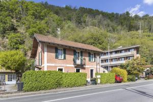 a building on the side of a road next to a building at La Veduta in Cannobio