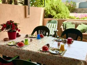 a table with plates and utensils on top at Sweet ColiLu in Stintino