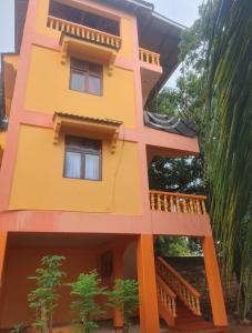 un modello di casa gialla con balcone di Malaika Diani Homes a Ukunda