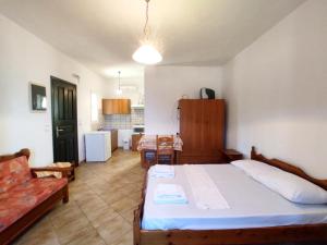 a bedroom with a bed and a living room at Zorgos Apartments in Zorgos 