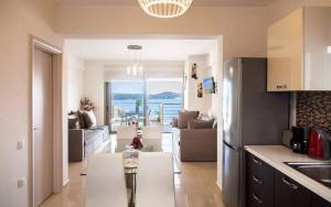 a kitchen and living room with a view of the ocean at Villa Maria PF in Nydri