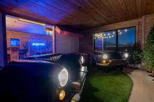 a living room with a couch and a car in it at Epic Views, 9Mi SR, GameRmTheater, HTub, Sauna in Bethel