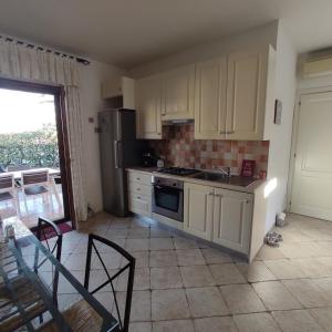 a kitchen with a sink and a stove top oven at Bellissima villa piscina 8 pax 1500 mt dal mare FMP-CAT01-PI in Monte Petrosu