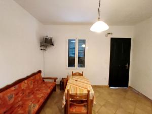a room with a table and a couch and a window at Zorgos Apartments in Zorgos 