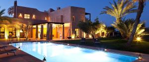 a large swimming pool in front of a house at Atmosphérique Paradise in Tamraght Ouzdar